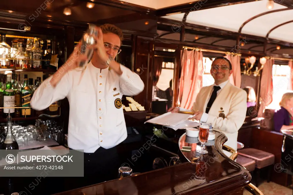 Shaking cocktails on board the Venice Simplon Orient Express train, heading for Venice, Italy