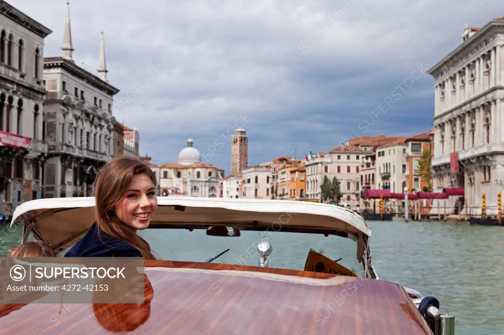 A young tourist enjoying the Grand Canal in Venice, Italy