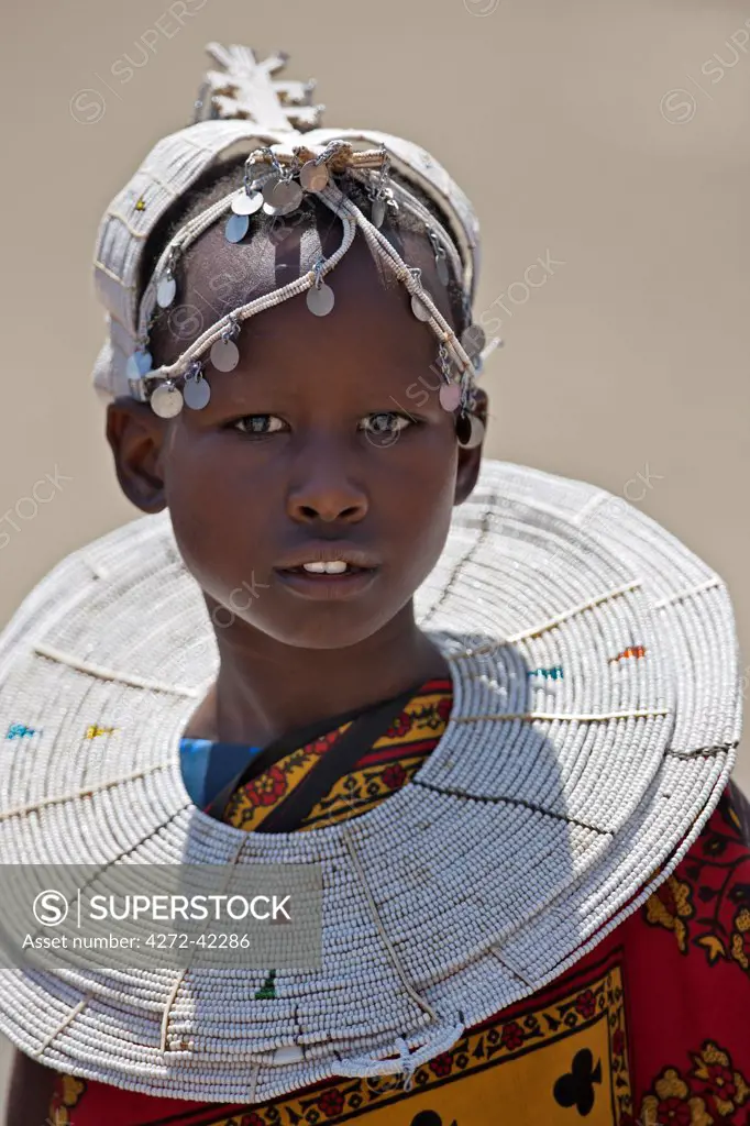 A young Maasai girl at Magadi. Her white beaded ornaments denote that she is a Kisongo Maasai, Kenya