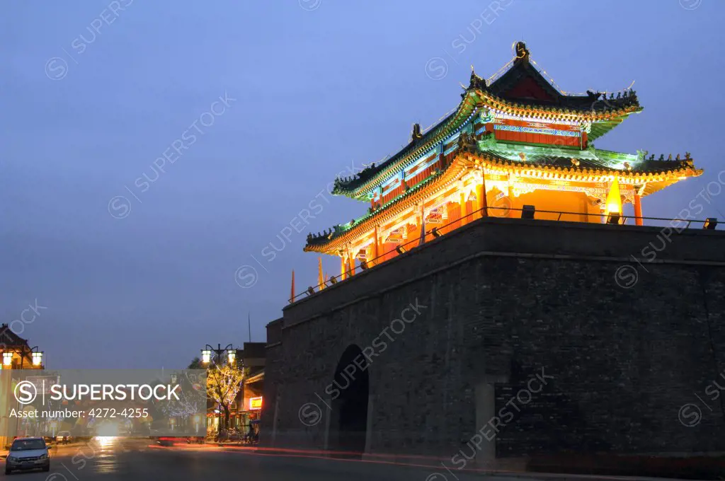 China, Shandong Province, Qufu City. Illuminated City Gate and watch tower - a Unesco World Heritage site.