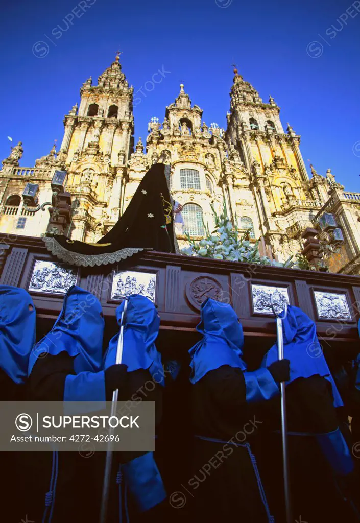 Santiago de Compostela, Galicia, Northern Spain, Nazzarenos carrying a statue of the Madonna in front of the Cathedral during Semana Santa