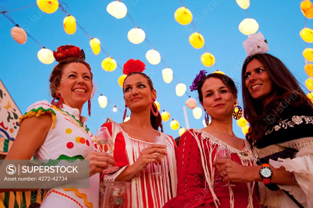Seville, Andalusia, Spain, Women in traditional flamenco dresses at the Feria de Abril