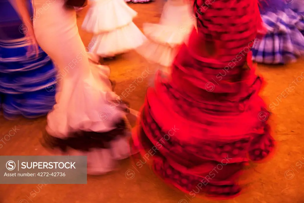 Seville, Andalusia, Spain, Detail of colourful flamenco dresses worn by women during the Feria de Abril