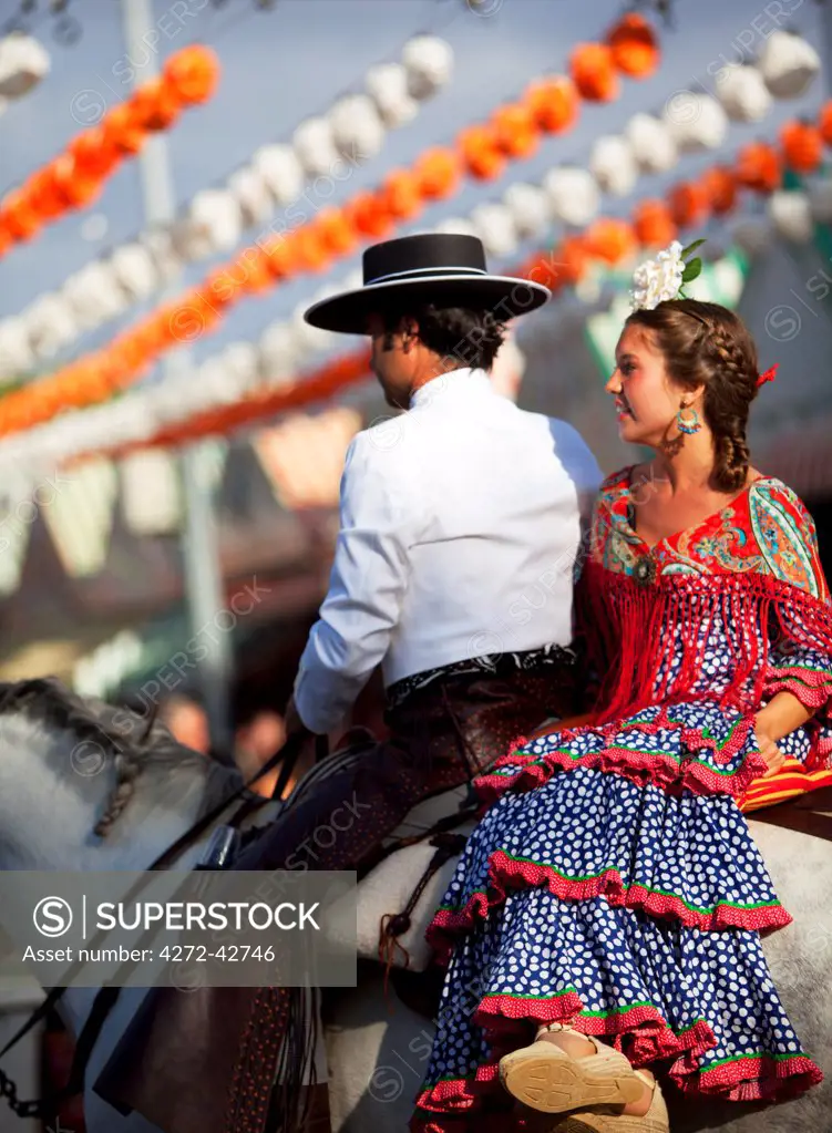 Seville, Andalusia, Spain, A young couple dressed in traditional clothes during the Feria de Abril