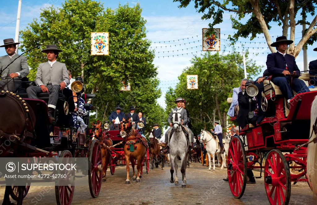 Seville, Andalusia, Spain, Horse drawn carriages and horse riders during the Feria de Abril