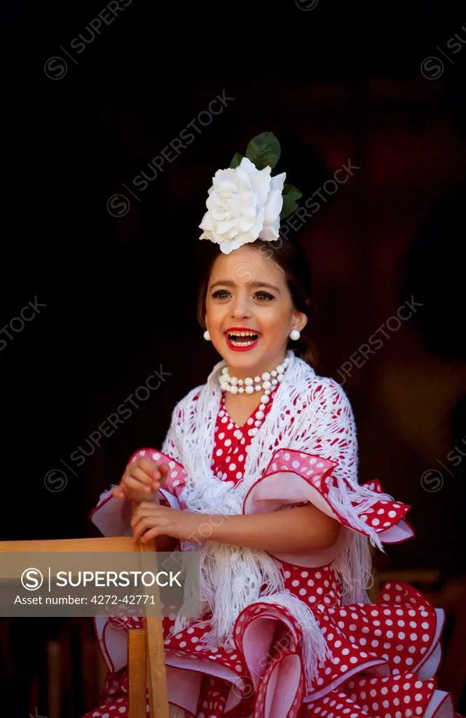 Seville, Andalusia, Spain, A girl in traditional flamenco dress at the Feria de Abril