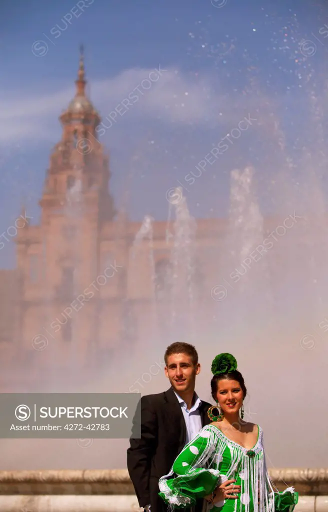 Seville, Andalusia, Spain, A young couple in front of the Plaza de Espana during the Feria de Abril