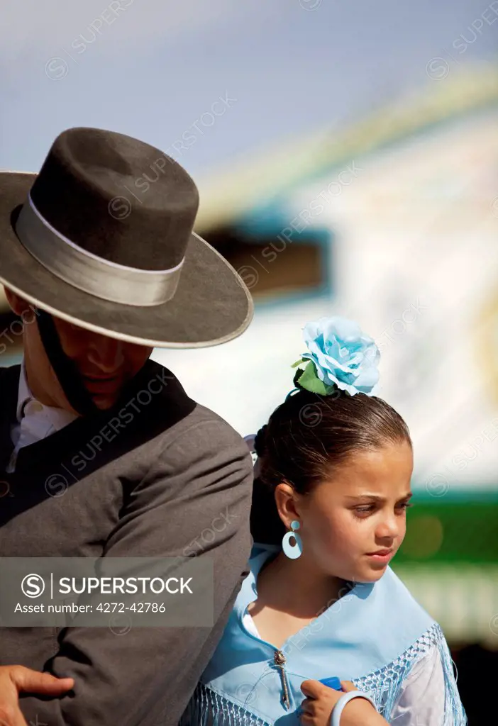 Seville, Andalusia, Spain, A girl with her father in traditional clothes at the Feria de Abril