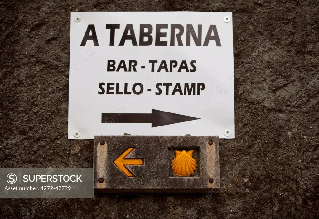 Spain, Galicia, Camino Frances, A sign advertising a bar on top of the Camino signs