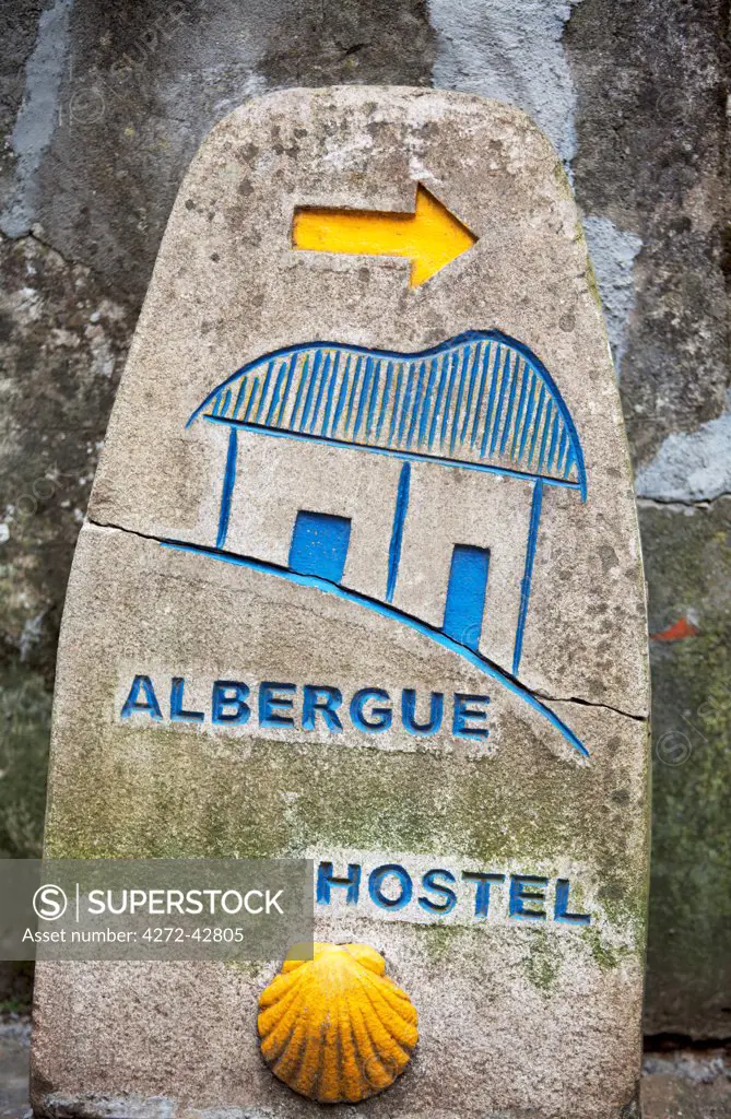 Spain, Galicia, Camino Frances, A stone sign with the typical shell indicating a hostel on the Camino