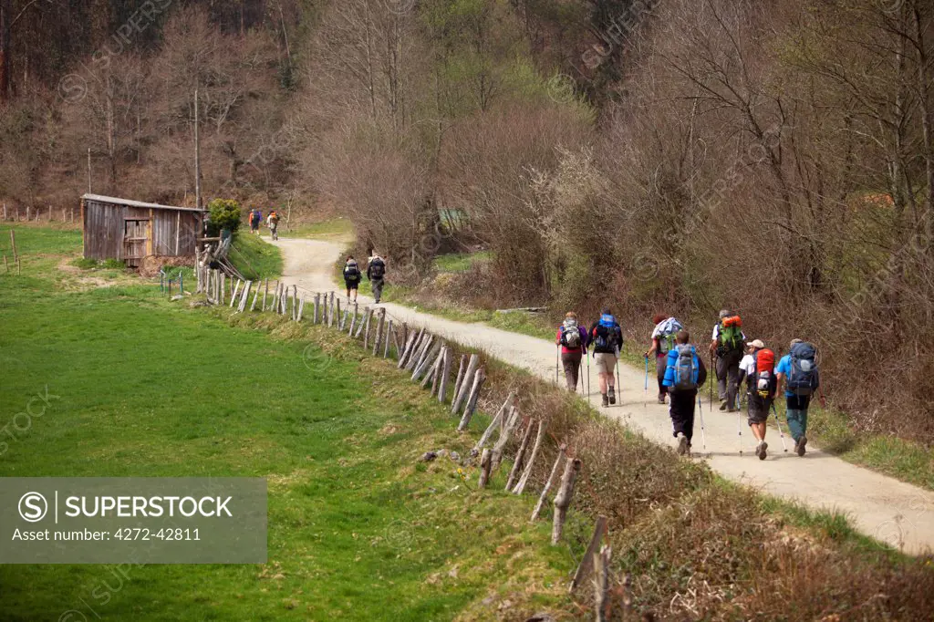Spain, Galicia, Camino Frances, Youths walking along the trail of the Camino