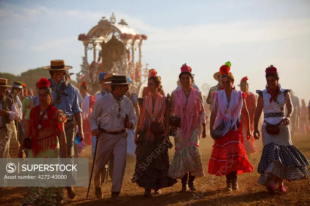 Seville, Andalusia, Spain. Pilgrims dressed in traditional clothes walking to the village of El Rocio during the El Rocio pilgrimage