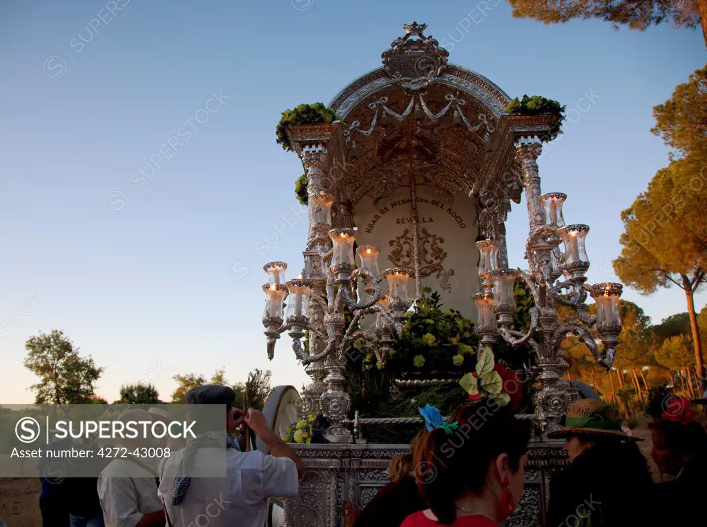 Huelva, Southern Spain. Believers carrying a float with the Madonna, early morning a days distance on foot from the village of El Rocio where the feast takes place