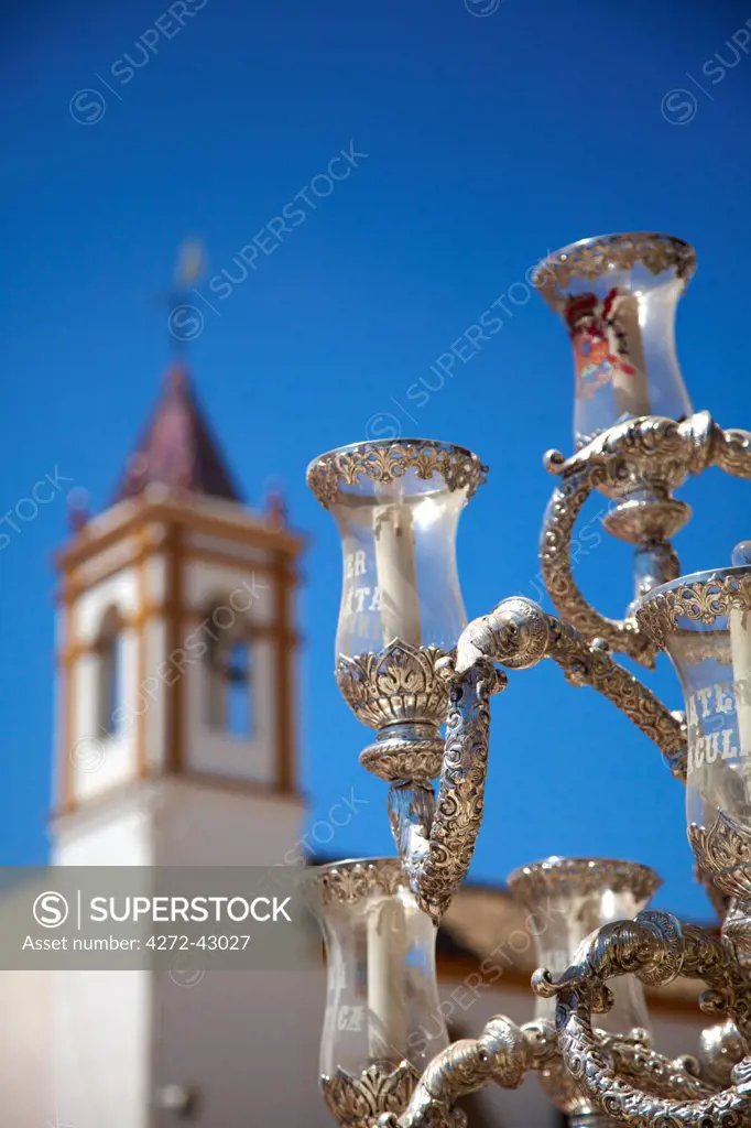 El Rocio, Huelva, Southern Spain. Detail of lamps on a cart and church tower during the annual Romeria