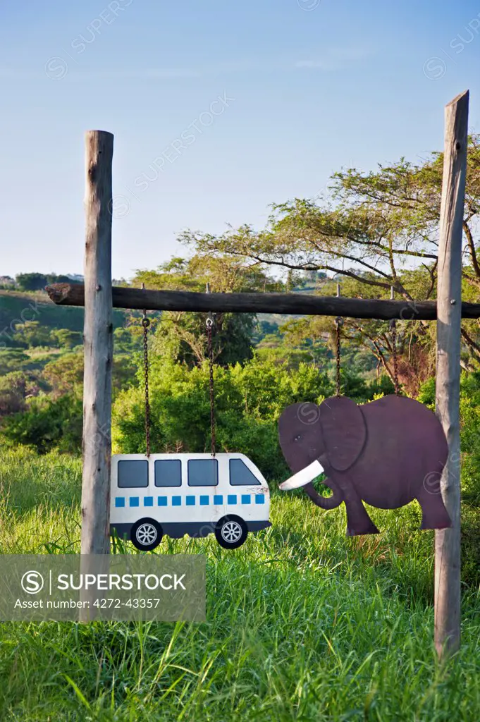 A graphic sign on the main road through Queen Elizabeth National Park warns of the danger posed by elephants to speeding minibus taxis, Uganda, Africa