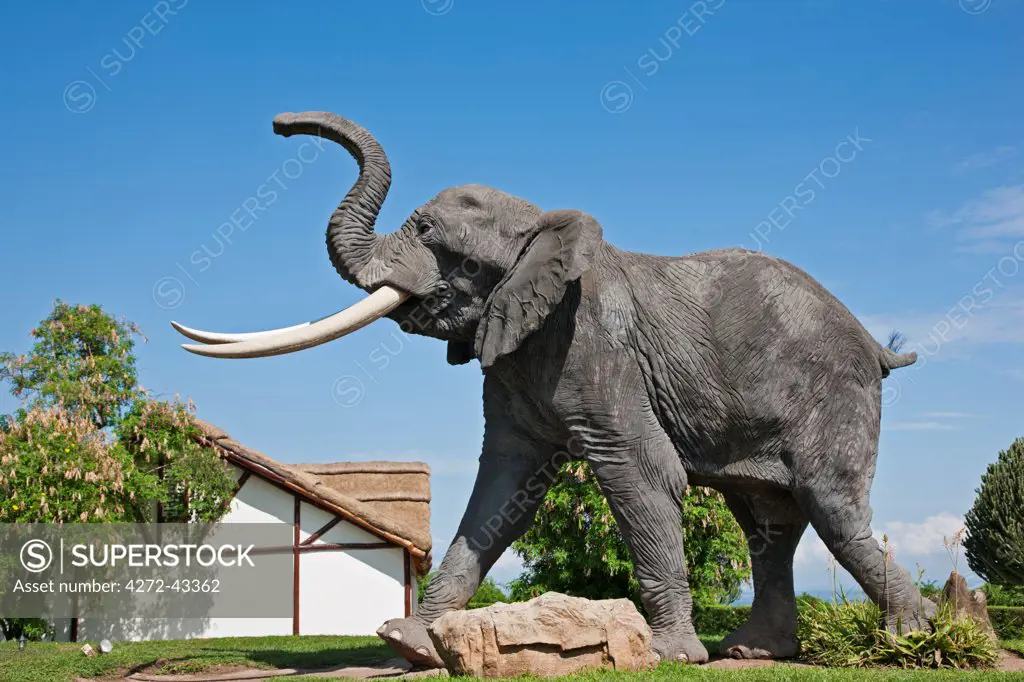 The larger than life size sculpture of an African elephant that stands at the entrance to the Mweya Safari Lodge in Queen Elizabeth National Park, Uganda, Africa