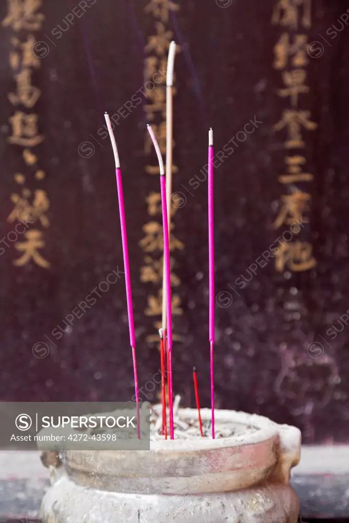 China, Yunnan, Tonghai. Burning incense sticks at the Taoist temple gardens in Xiushan Mountain Park in Tonghai.