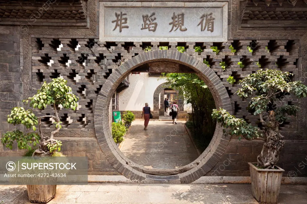 China, Yunnan, Jianshui. A moon gate at the Zhu Family Garden Hotel, an old Chinese mansion dating back to the Qing Dynasty, in Jianshui.