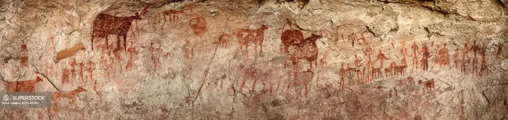 Chad, Gaora Hallagana, Ennedi, Sahara. An ancient rock painting of human figures and their livestock during the Pastoral Period.