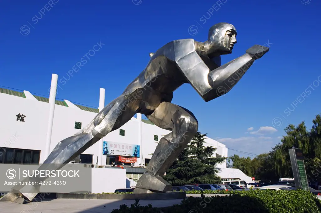 China, Beijing. A modern ice skater monument at the indoor ice skating training centre.