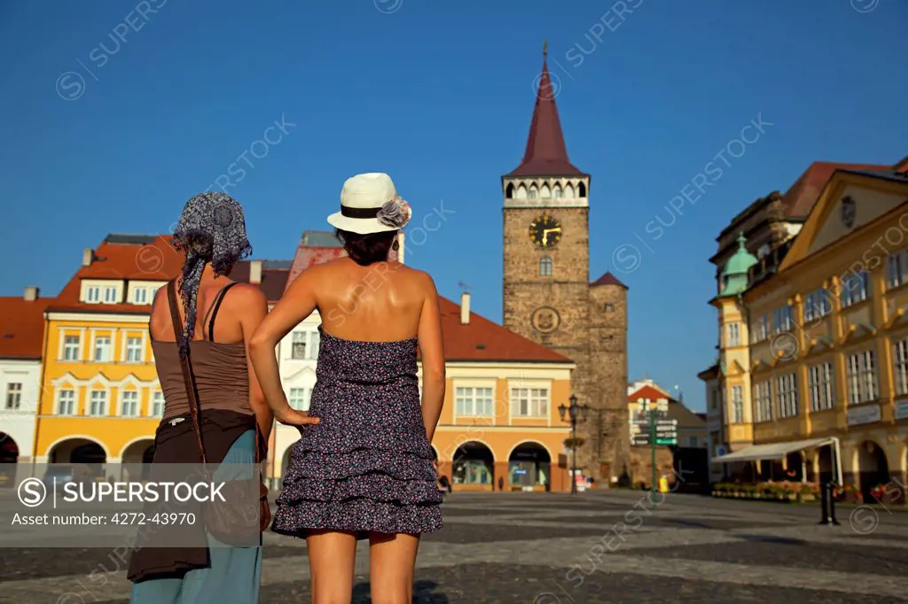 Czech Republic, Bohemia, Hradec Kralove, Jicin. Two young woman standing in the main square. MR