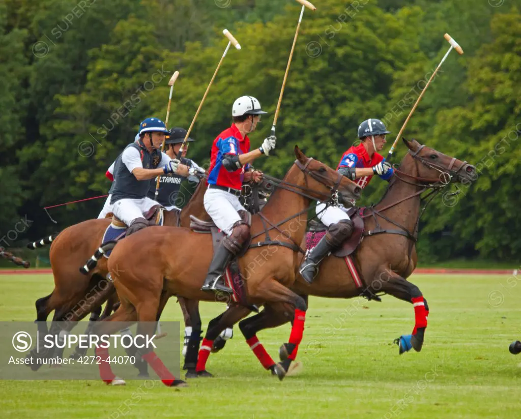 UK, Gloucestershire. A polo match in full swing at the Beaufort Polo Club.