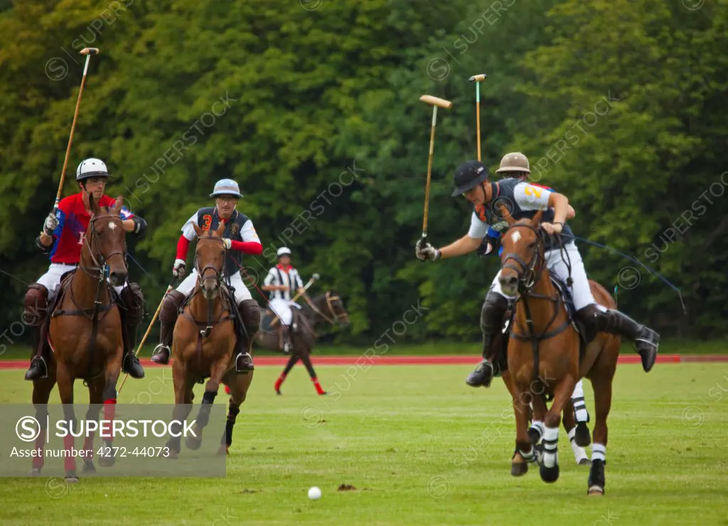 UK, Gloucestershire. A polo match in full swing at the Beaufort Polo Club.