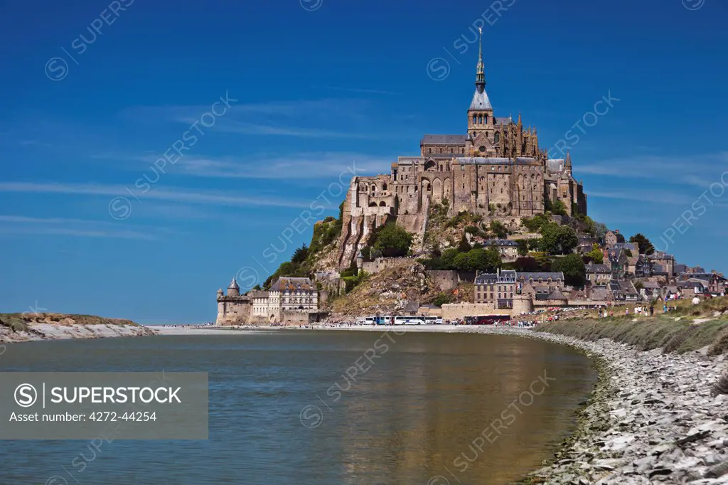 Mont Saint Michel and its connection to the mainland via a tidal causeway with the River Couesnon on the left at high tide, Le Mont Saint Michel, Basse Normandie, France.