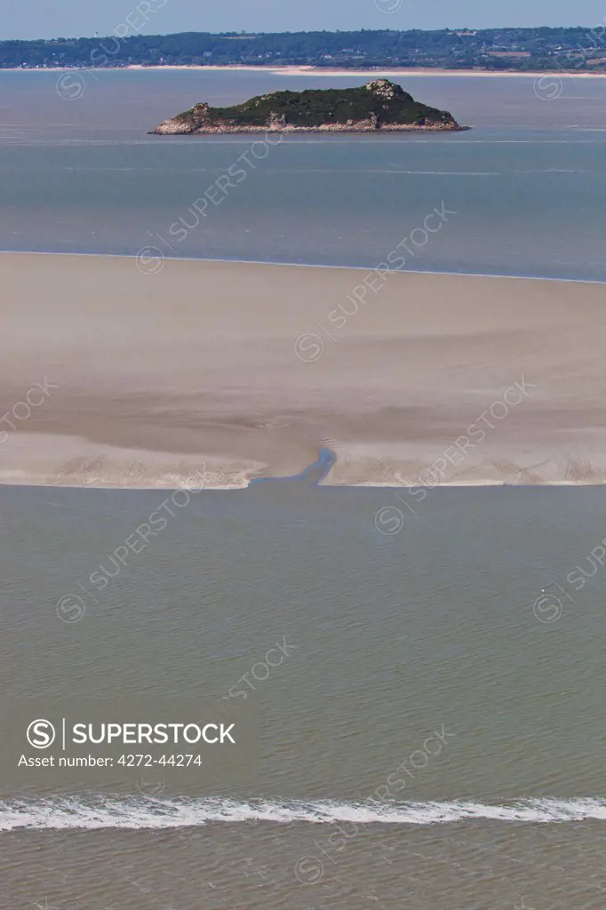 Overview of the bird sanctuary, the  Island of Tombelaine and the mouth of the Selune River leading to the English Channel viewed from the West Terrace of Mont Saint Michel, Le Mont Saint Michel, Basse Normandie, France.
