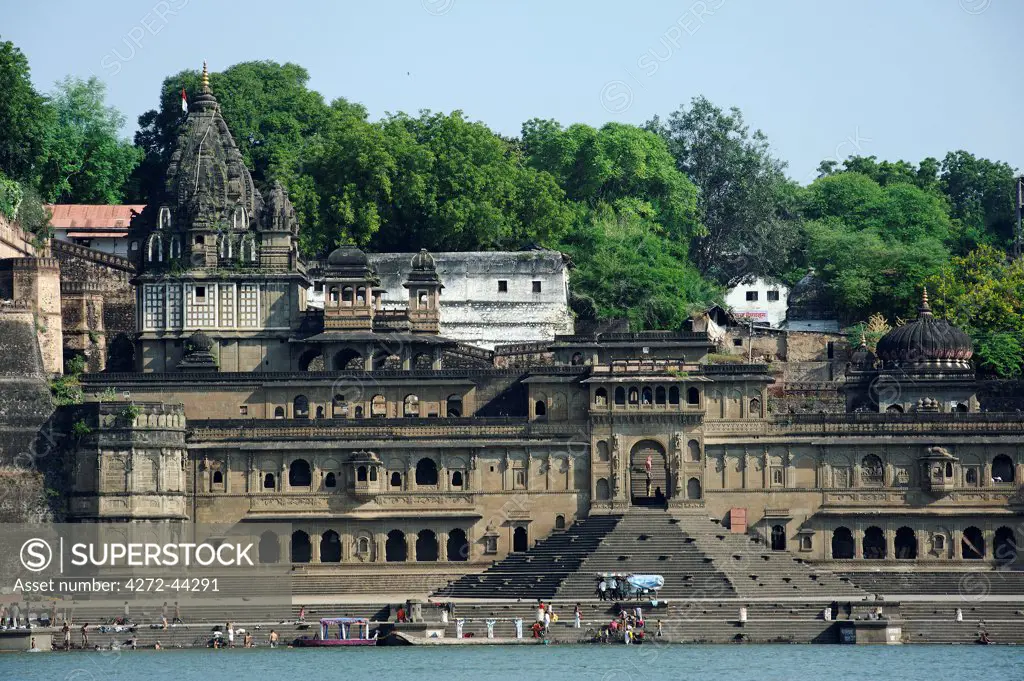 India, Madhya Pradesh, Maheshwar. Below Ahilya Fort and beside the Narmada River's bathing ghats stand elaborate chhatris, or mausouleums, of Ahilya Bai Holkar.