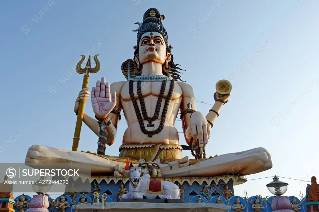 India, Madhya Pradesh, Omkareshwar. A huge statue of the Hindu god Shiva, known as the Shiv Pratima, dominates the Maa Rajrajeshwari temple at Omkareshwar, an island in the Narmada River.