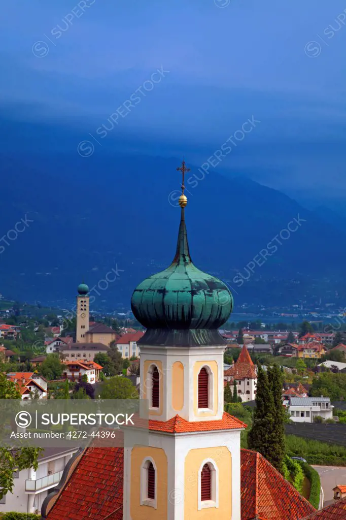 Northern Italy, Trentino, Alto Adige, Sud Tyrol. A bell tower from the church of a monestary overlooking the small town of Lana and mountains
