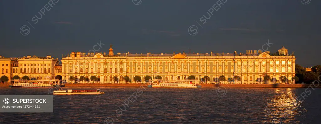 Russia, St.Petersburg. The State Hermitage Museum viewed across the Neva in dramatic evening light during the white nights.