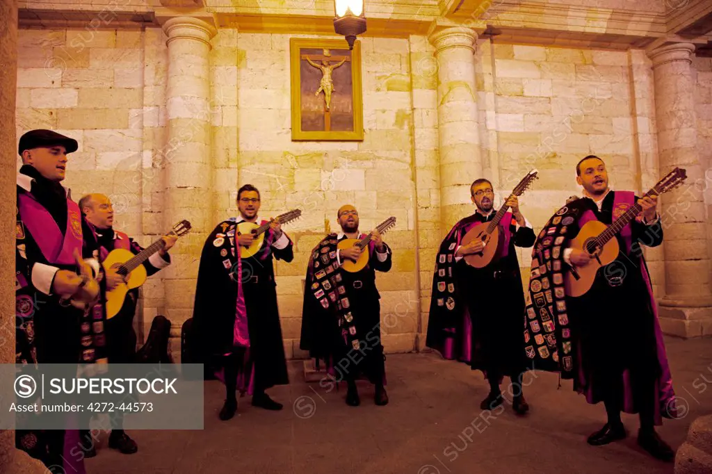 Spain, Galicia, Santiago de Compostela. Musicians in traditional attire singing traditional Galician songs