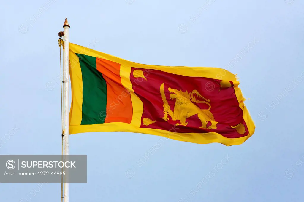 The Sri Lankan national flag flying from a flagpole on Moon Bastion in Galle Fort, Sri Lanka