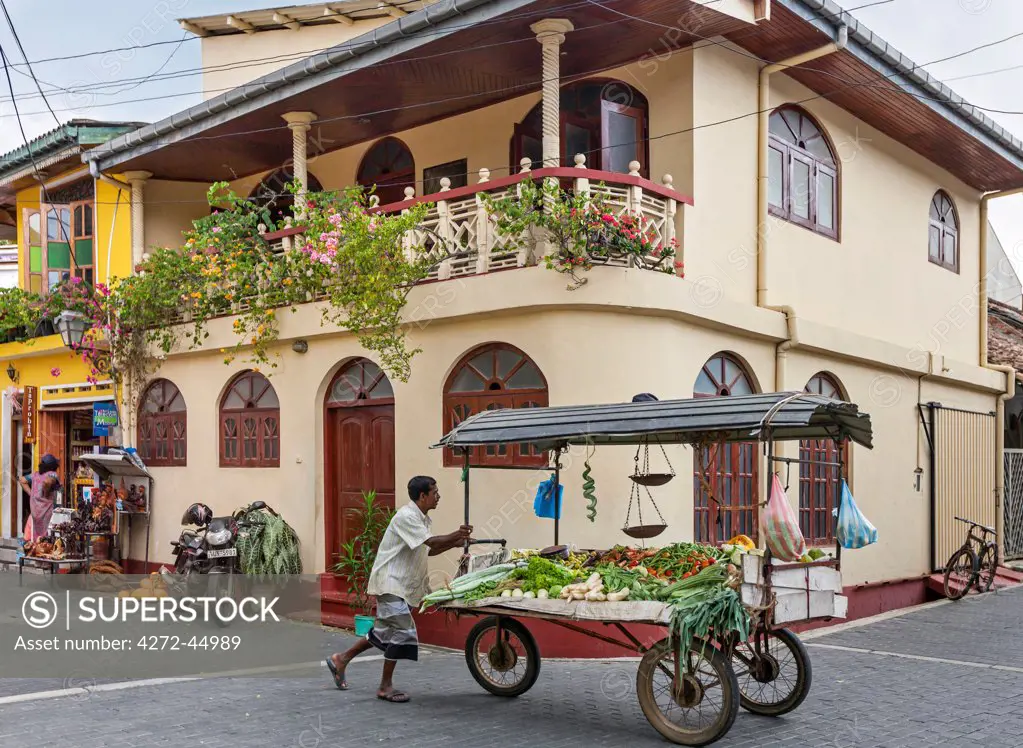 A vegetable seller pushes his cart through the streets of Galle Fort, which was built by the Dutch in the 17th century, Sri Lanka