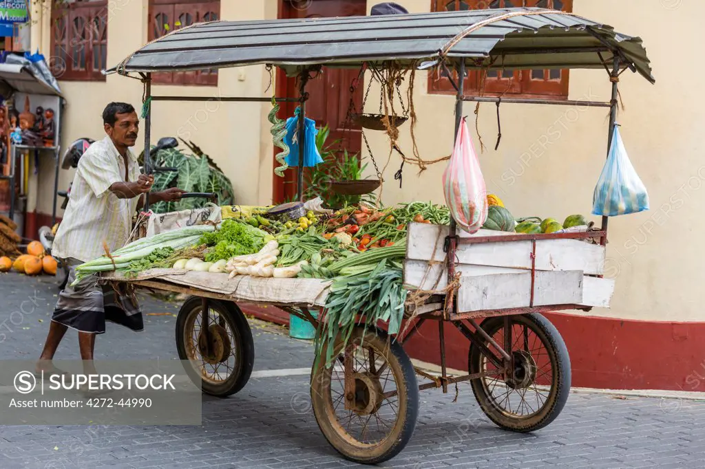 A vegetable seller pushes his cart through the streets of Galle Fort, which was built by the Dutch in the 17th century, Sri Lanka