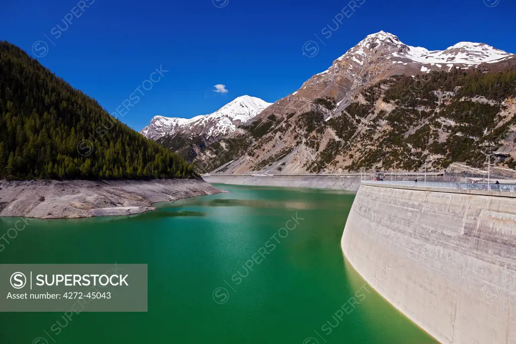 The Punt da Gall  hydroelectric dam on the Swiss / Italian Border with Lago di Livigno with the Piz da l'Acqua Mountain in the background, located in the Il Fuorn National Park, Kanton Graubunden, Switzerland.