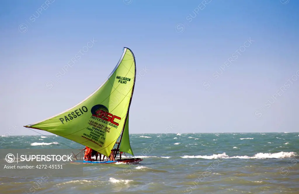 South America, Brazil, Ceara, Fortaleza, a jangada sailing in Canoa Quebrada. The jangada is said to be the only slightly modified descendant of the boats used by Odysseus