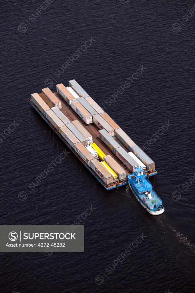 Brazil, Amazonas, container barge and tug on the Rio Negro in Manaus in the Brazilian Amazon