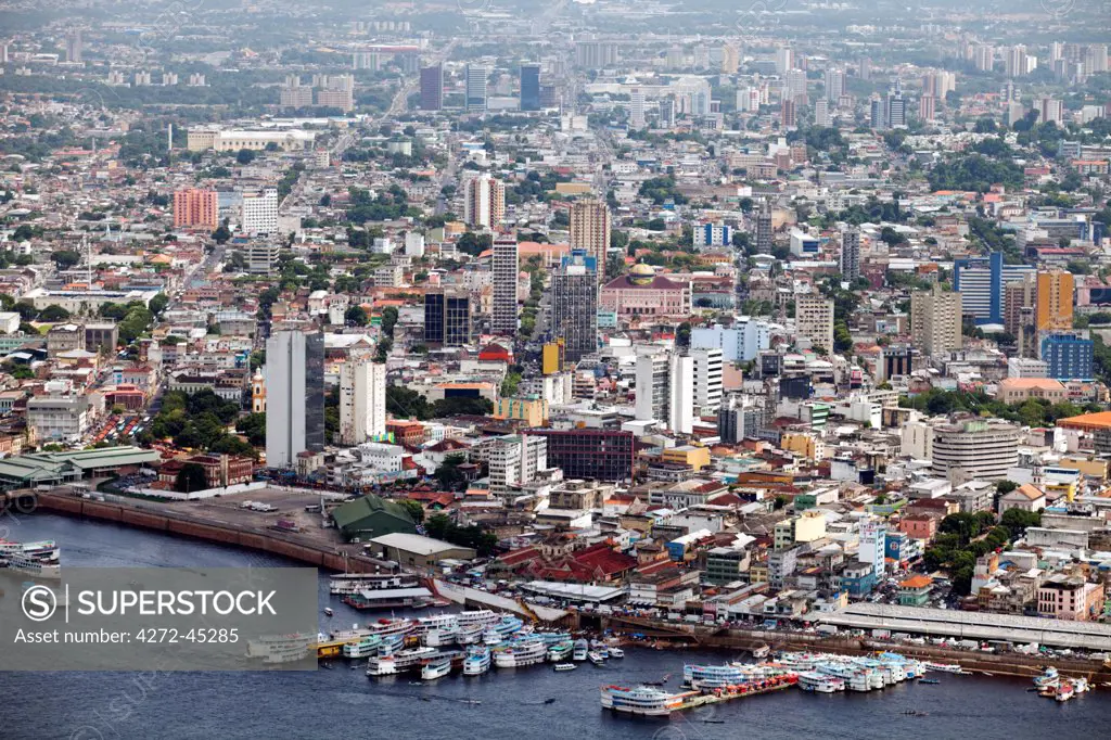South America, Brazil, Amazonas state, Manaus, aerial view of the city centre of Manaus showing river boats at the floating docks, the Adolpho Lisboa market and the Opera House