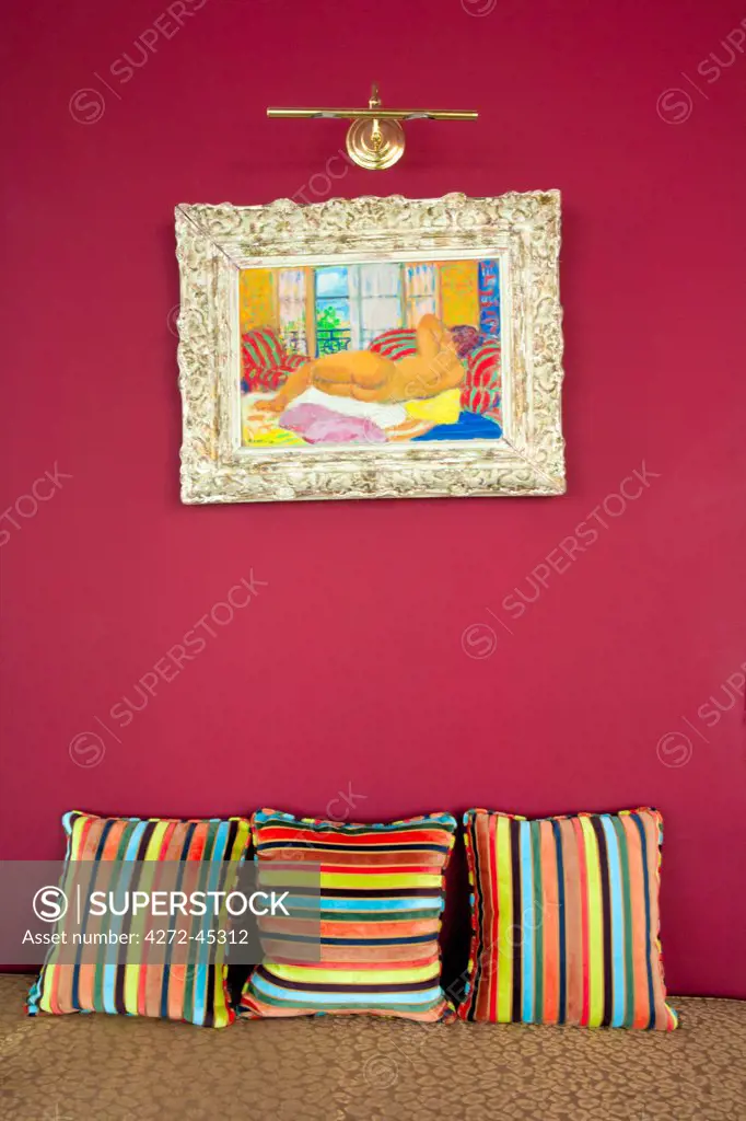 Brazil, Rio de Janeiro city, Gavea, La Suite Hotel, an impressionist painting and scatter cushions on a chaise longue in the hotel lobby PR