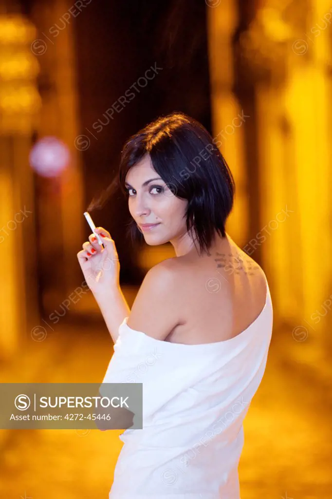 South America, Brazil, Para, Belem, a woman stands with a cigarette in the old colonial part of Belem in the Brazilian Amazon