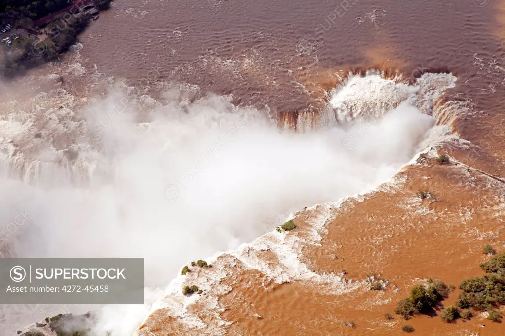 South America, Brazil, Parana, aerial view of the Devils Throat at the Iguazu falls when in full flood and lying on the frontier of Brazil and Argentina.