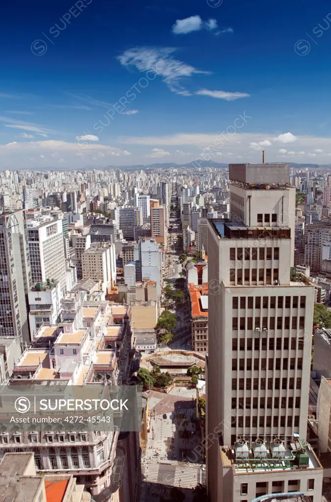 South America, Brazil, Sao Paulo; view along Avenida Sao Joao from the top of the Banespa Tower showing the roof of the Martinelli building in the foreground, Nossa Senhora do Rosario church and the Largo do Paicandu