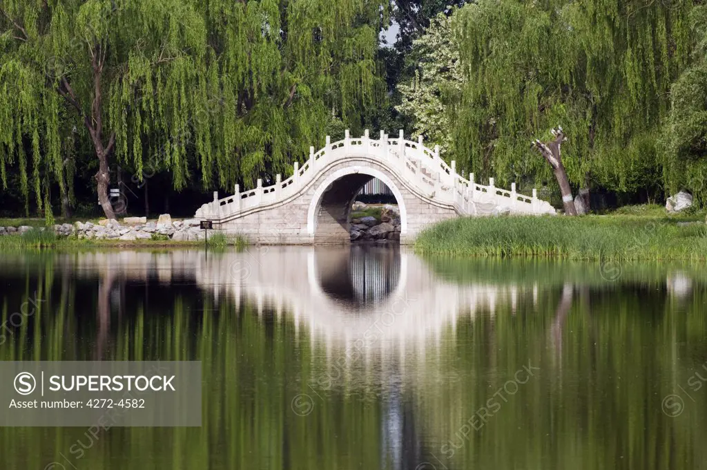 China, Beijing. Old Summer Palace - an arched stone bridge.