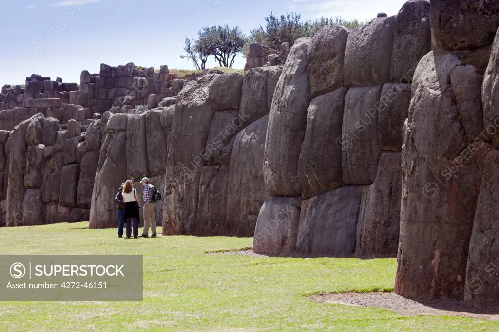 South America, Peru, Cusco, Sacsayhuaman. Tourists at the Inca ceremonial site of Sacsayhuaman near the UNESCO World Heritage listed former Inca capital of Cusco