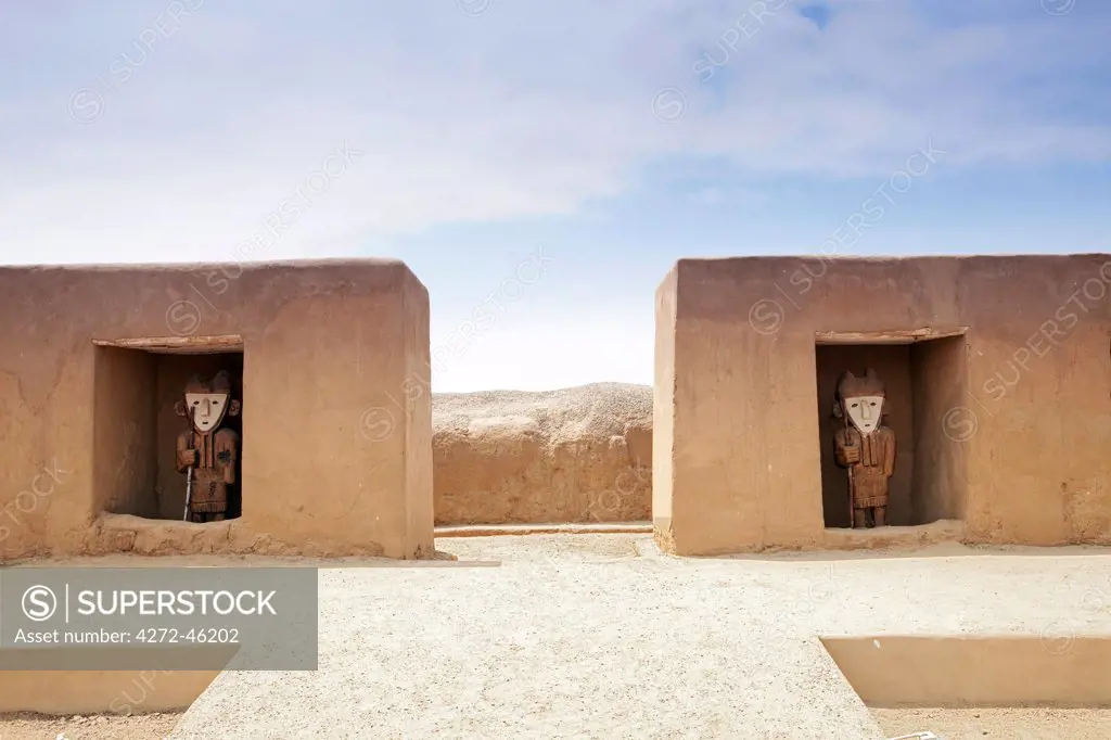 South America, Peru, La Libertad, Trujillo, wooden statues set in alcoves in an adobe wall in the Chimu city of Chan Chan a World Heritage site