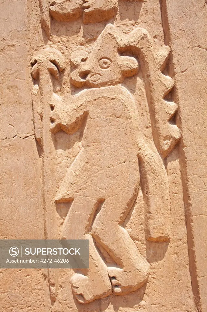 South America, Peru, La Libertad, Trujillo, an adobe bas relief from a mural on the Chimu House of the Dragon showing a figure in a headdress, part of the UNESCO World Heritage Listed Chan Chan archeological complex