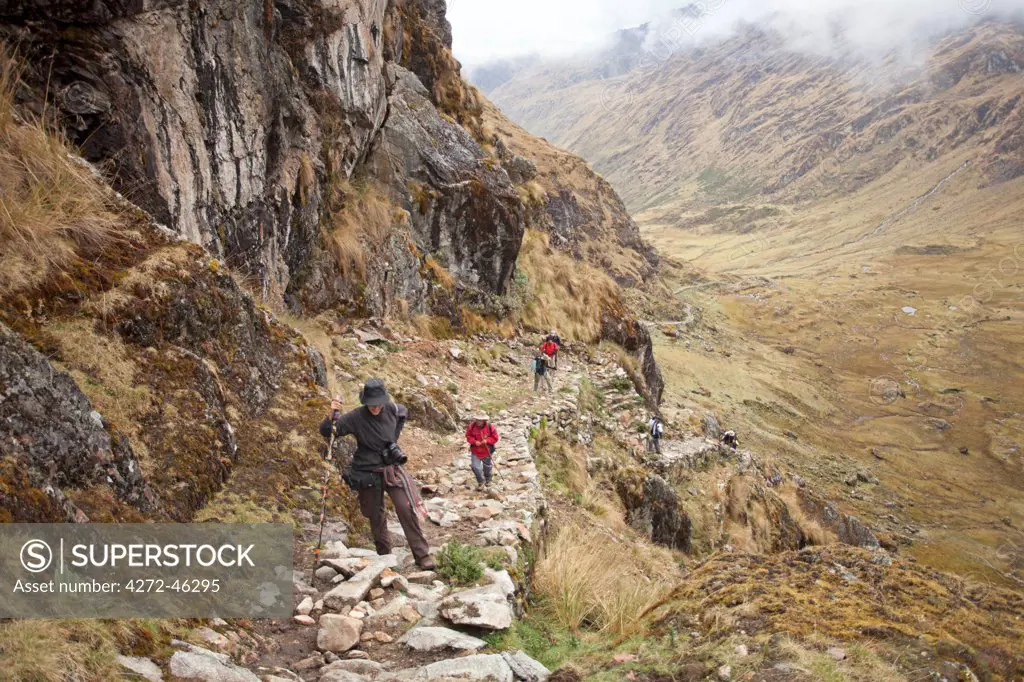 South America, Peru, Cusco. Hikers on an Inca road on the trail to Choquequirao